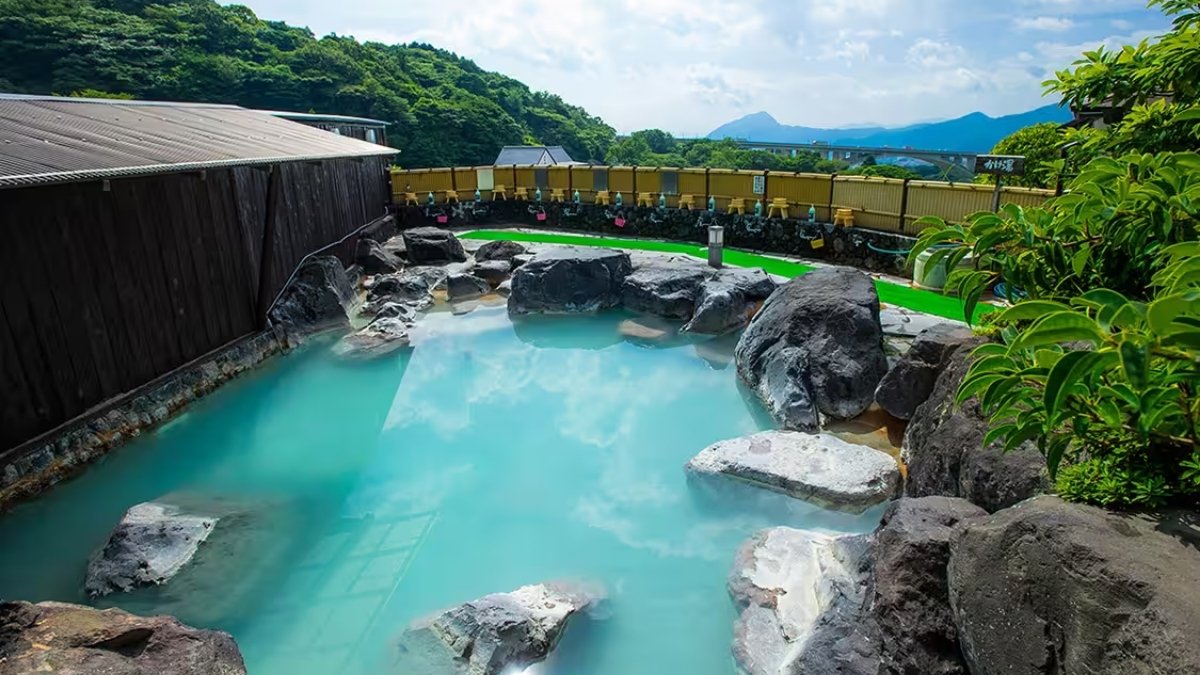 Beppu Onsen, Japanese geothermal hot spring with steam vents and terraces.