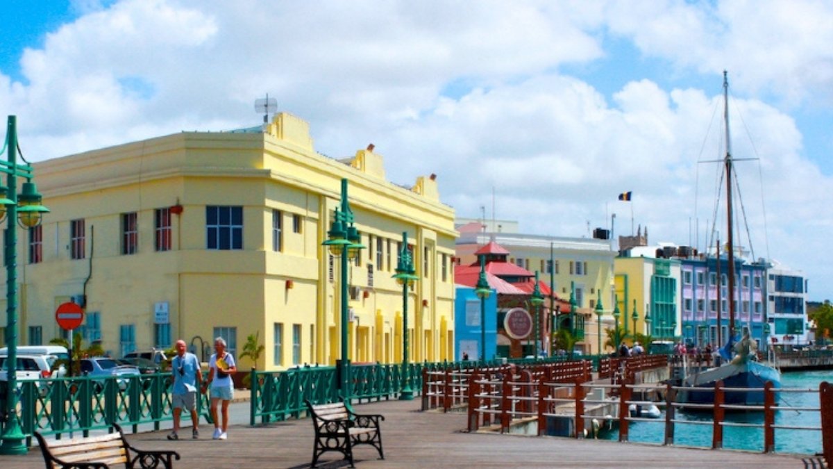 Aerial view of Bridgetown, the capital of Barbados, showing the colonial buildings and turquoise Caribbean Sea under a sunny sky.