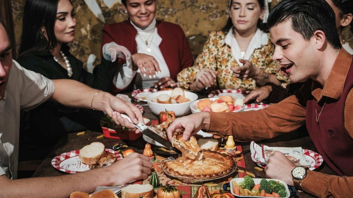 Americans celebrating Thanksgiving 2025 by sharing festive meal and giving thanks together.