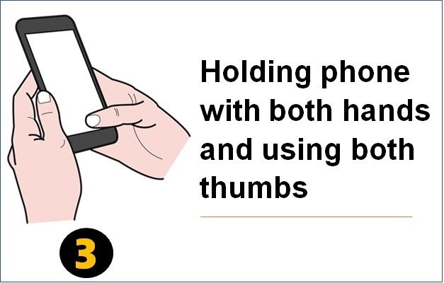 Holding phone with both hands and using both thumbs