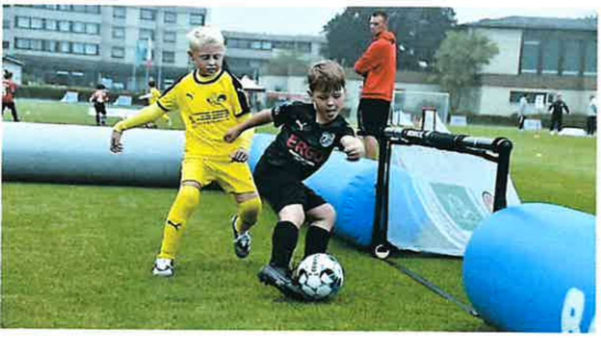 Two students in a field with a football.