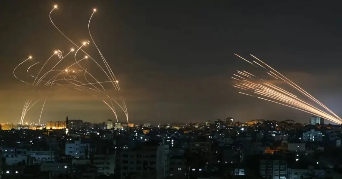 On May 13, 2023, rockets launched from Gaza and intercepted by Israel's Iron Dome anti-missile system are visible over Israeli skies, as seen from Gaza City